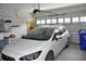 Garage interior featuring a parked car, shelving, and overhead door system at 1308 Riverport Dr., Conway, SC 29526