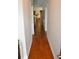 Long hallway featuring gleaming hardwood floors, providing an elegant and spacious feel throughout the home at 1308 Riverport Dr., Conway, SC 29526