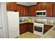 Kitchen featuring granite counters, tile backsplash, stainless steel appliances, and dark wood cabinets at 1308 Riverport Dr., Conway, SC 29526