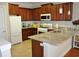 Stylish kitchen with granite countertops, stainless steel appliances, and dark wood cabinets at 1308 Riverport Dr., Conway, SC 29526