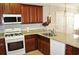 Modern kitchen with granite countertops, stainless steel appliances and dark wood cabinetry at 1308 Riverport Dr., Conway, SC 29526