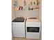 Laundry room with modern Whirlpool washer and dryer, and overhead wire shelving at 1308 Riverport Dr., Conway, SC 29526