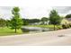 Scenic view of pond surrounded by well-maintained lawns and colorful homes in a tranquil setting at 1308 Riverport Dr., Conway, SC 29526