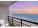 This balcony shows a gorgeous scenic view of the beach at sunset with patio furniture on the balcony at 1501 S Ocean Blvd. # 1044, Myrtle Beach, SC 29577