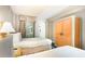 Bright bedroom featuring two beds with white bedding and light wood headboards and wardrobe at 1501 S Ocean Blvd. # 1044, Myrtle Beach, SC 29577