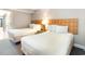 Bright bedroom featuring two beds with white bedding and light wood headboards at 1501 S Ocean Blvd. # 1044, Myrtle Beach, SC 29577