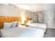Bright bedroom featuring two beds with white bedding and light wood headboards and balcony at 1501 S Ocean Blvd. # 1044, Myrtle Beach, SC 29577