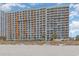 Beachside condo showcasing multiple levels of private balconies and exterior design from the sand at 1501 S Ocean Blvd. # 842, Myrtle Beach, SC 29577