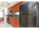 Cozy kitchen features cherry cabinets, black appliances, and granite countertops at 1501 S Ocean Blvd. # 842, Myrtle Beach, SC 29577