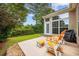 Outdoor patio with chairs overlooking a green lawn and lush landscaping at 1504 Sedgefield Dr., Murrells Inlet, SC 29576