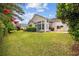 Large backyard features a well-manicured lawn, mature trees and a covered outdoor patio at 1504 Sedgefield Dr., Murrells Inlet, SC 29576