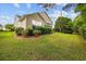 Landscaped backyard with lush green lawn, manicured bushes and view of the home's exterior at 1504 Sedgefield Dr., Murrells Inlet, SC 29576