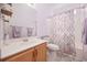 Bathroom with a single sink vanity and a shower with patterned curtain at 1504 Sedgefield Dr., Murrells Inlet, SC 29576