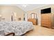 Well-lit bedroom showcasing wood flooring, a tall dresser with a mirror, and a ceiling fan at 1504 Sedgefield Dr., Murrells Inlet, SC 29576