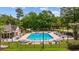 Community pool surrounded by lounge chairs and umbrellas, offering a relaxing atmosphere at 1504 Sedgefield Dr., Murrells Inlet, SC 29576