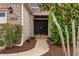 Close-up of the double front door with brick facade, lush landscaping, and walkway at 1504 Sedgefield Dr., Murrells Inlet, SC 29576
