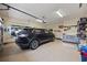 Spacious garage with epoxy floors featuring a parked SUV and ample storage solutions at 1504 Sedgefield Dr., Murrells Inlet, SC 29576