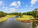 Scenic view of the golf course, with lush green fairways, a pond, and mature trees at 1504 Sedgefield Dr., Murrells Inlet, SC 29576