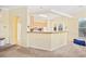 Open-concept kitchen with breakfast bar, wood cabinets, and plenty of natural light at 1504 Sedgefield Dr., Murrells Inlet, SC 29576