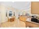 Bright kitchen featuring natural wood cabinets, light countertops, and a cozy breakfast nook with abundant natural light at 1504 Sedgefield Dr., Murrells Inlet, SC 29576