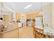 Open kitchen featuring light wood cabinets, white appliances, and a breakfast table at 1504 Sedgefield Dr., Murrells Inlet, SC 29576