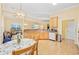 Sunlit kitchen with wood floors, breakfast table, light wood cabinets, and bright lighting at 1504 Sedgefield Dr., Murrells Inlet, SC 29576