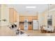 Bright kitchen with wood cabinets, light appliances and a breakfast table in natural light at 1504 Sedgefield Dr., Murrells Inlet, SC 29576