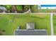 The backyard boasts manicured lawn, a pergola covered concrete patio and a pool next door at 155 Marsh Deer Place, Surfside Beach, SC 29575