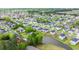 A picturesque aerial view of a community, revealing its tranquil pond and neatly arranged homes at 155 Marsh Deer Place, Surfside Beach, SC 29575