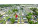 An aerial shot displays the neighborhood, highlighting its proximity to a pond, lush trees, and green spaces at 155 Marsh Deer Place, Surfside Beach, SC 29575