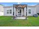 The backyard has a concrete patio covered by a pergola, sliding glass doors to the house at 155 Marsh Deer Place, Surfside Beach, SC 29575