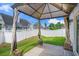 Cozy backyard patio with a shaded pergola, string lights, and a view of the grassy lawn at 155 Marsh Deer Place, Surfside Beach, SC 29575
