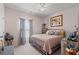 A well-lit bedroom with a bed, a ceiling fan and a decorative art collection at 155 Marsh Deer Place, Surfside Beach, SC 29575