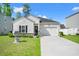 Charming single-story home with a well-manicured lawn and attached garage in a desirable neighborhood at 155 Marsh Deer Place, Surfside Beach, SC 29575