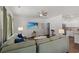 Cozy living room with a large sectional couch, ceiling fan, and a mounted television at 155 Marsh Deer Place, Surfside Beach, SC 29575