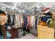A walk-in closet is highly organized with labelled bins, shelves, and hanging clothes at 155 Marsh Deer Place, Surfside Beach, SC 29575