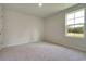 Bright bedroom with plush carpeting and a large window at 162 Waterloo Sunset Dr., Longs, SC 29568