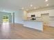 Open-concept living space showcases a modern kitchen with white cabinets and stainless steel appliances at 162 Waterloo Sunset Dr., Longs, SC 29568