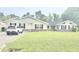 Ranch style home with black shutters, light siding and front yard with a car parked in the driveway at 1769 Crooked Pine Rd., Surfside Beach, SC 29575