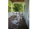 Cozy back porch with rocking chairs and cushioned seating, perfect for relaxing and enjoying outdoor views at 18 Trigger Fish Ln., Murrells Inlet, SC 29576