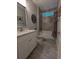 Modern bathroom features a tub with tiled backsplash, granite counters, and decorative wall art at 18 Trigger Fish Ln., Murrells Inlet, SC 29576