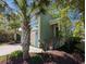 Inviting two-story home with lush landscaping and a front entrance accessible by stairs, offering curb appeal at 18 Trigger Fish Ln., Murrells Inlet, SC 29576