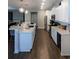 Modern kitchen with white cabinets, stainless steel appliances, and a long island with seating at 18 Trigger Fish Ln., Murrells Inlet, SC 29576