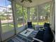 Cozy screened porch with comfortable seating, ideal for enjoying the outdoors in any weather at 18 Trigger Fish Ln., Murrells Inlet, SC 29576