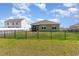Backyard of home has a black metal fence, grass, and green house at 1804 Castlebay Dr., Conway, SC 29526