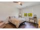 Bright bedroom with a ceiling fan, a bed, a mirror and a writing desk near a window at 1804 Castlebay Dr., Conway, SC 29526