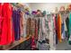 Walk-in closet with wire shelving, hanging clothes, handbags, and a lower dresser at 1804 Castlebay Dr., Conway, SC 29526