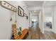 Hallway with wood flooring, decorative bench, and views to the dining room and bedroom at 1804 Castlebay Dr., Conway, SC 29526