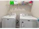 Laundry room with white washer and dryer and metal shelving at 1804 Castlebay Dr., Conway, SC 29526