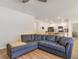 Living room with a large light blue couch, ceiling fan, and view to the kitchen at 1804 Castlebay Dr., Conway, SC 29526